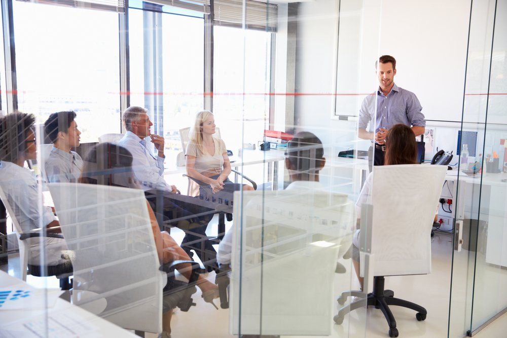 Employees at a meeting in a modern glass office