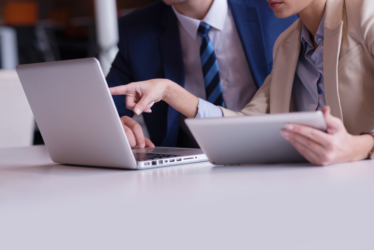 Employees looking on laptop using cloud computing